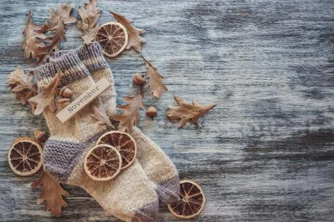 Pair of woolen socks and different dry decorations, wooden background Stock-Fotos