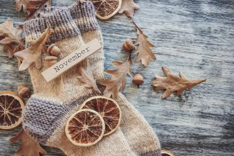 Pair of woolen socks and different dry decorations, wooden background Stock Photos