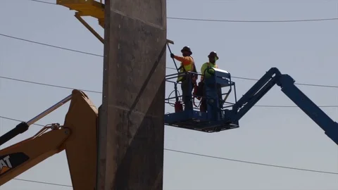 A pair of workers scraping a concrete panel standing on a telehandler 스톡 동영상 99043228