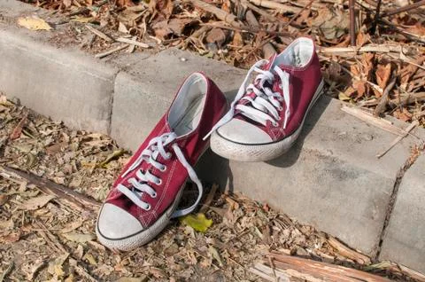 Pair of worn sneakers Stock Photos