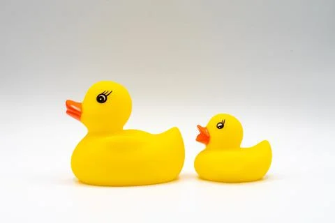 Pair of yellow ducks with red beaks baby bath toy isolated on white backgroun Stock Photos