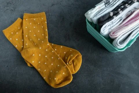A pair of yellow socks on dark background Stock Photos