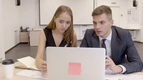 Pair of young financial analytics are working in their start-up office. Stock Footage 86636867