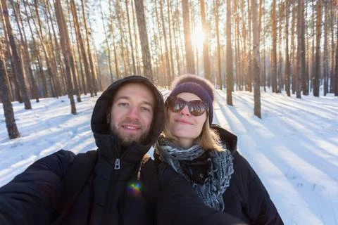 A pair of young people on a background of pine forest Stock Photos