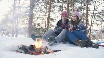 A pair of young people in winter clothes in a snow-covered forest fry Stock Footage 85952960