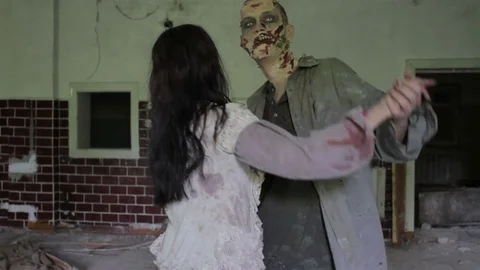A pair of zombies are dancing a waltz in the large hall of an abandoned building Stock Footage 77453512