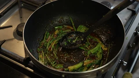 Pak Choi And Chilli Paste Being Stirred In Oil Inside Wok. Slow Motion Stock Footage 220271492