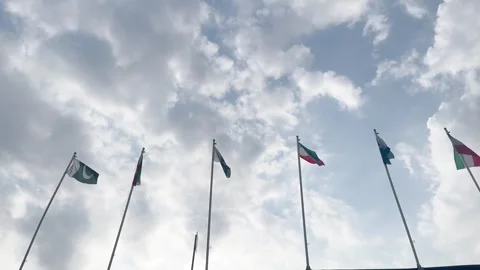 Pakistan and Iran two flags on flagpoles and blue cloudy sky Stock Footage 343612259