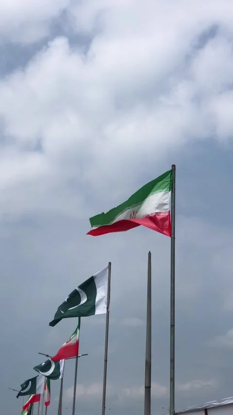 Pakistan and Iran two flags on flagpoles and blue cloudy sky,  스톡 동영상 344648835