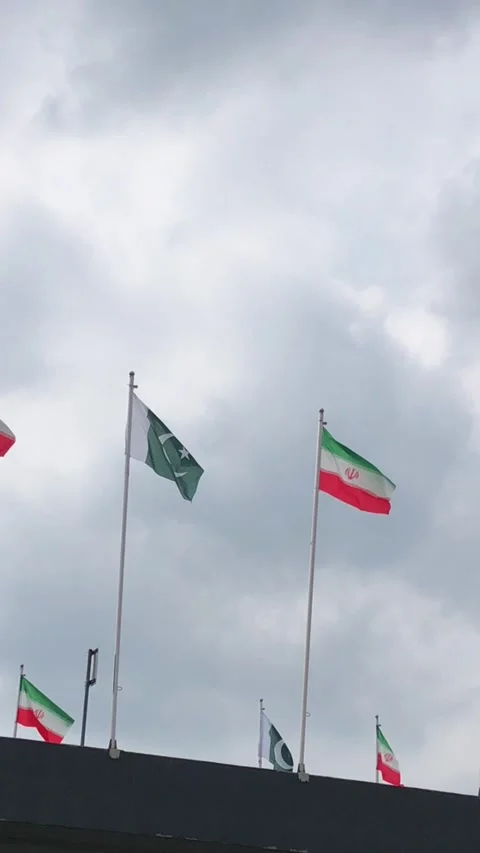 Pakistan and Iran two flags on flagpoles and blue cloudy sky,  動画素材 344648838