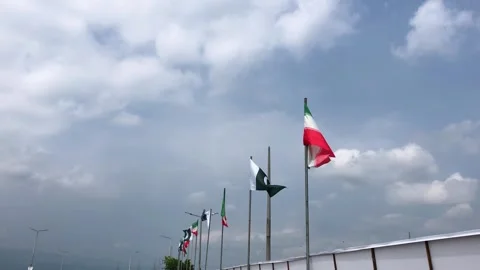 Pakistan and Iran two flags on flagpoles and blue cloudy sky,  스톡 동영상 344648993
