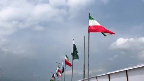 Pakistan and Iran two flags on flagpoles and blue cloudy sky,  스톡 동영상 344648994