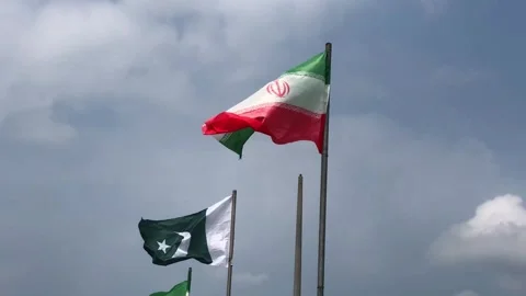 Pakistan and Iran two flags on flagpoles and blue cloudy sky,  動画素材 344649236