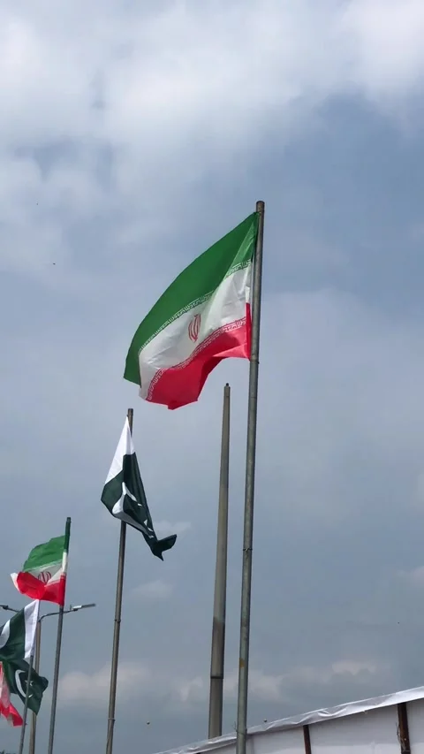 Pakistan and Iran two flags on flagpoles and blue cloudy sky,  스톡 동영상 344649237