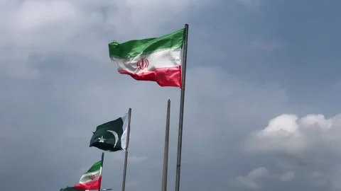 Pakistan and Iran two flags on flagpoles and blue cloudy sky,  스톡 동영상 344649293