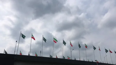 Pakistan and Iran two flags on flagpoles and blue cloudy sky 스톡 동영상 344649301