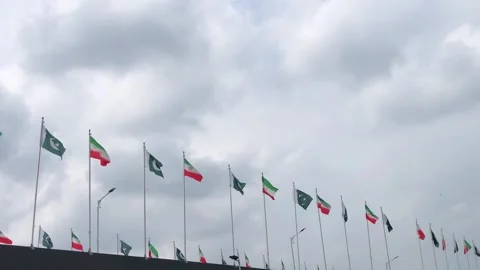 Pakistan and Iran two flags on flagpoles and blue cloudy sky,  스톡 동영상 344649690