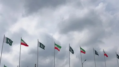 Pakistan and Iran two flags on flagpoles and blue cloudy sky,  스톡 동영상 344649694