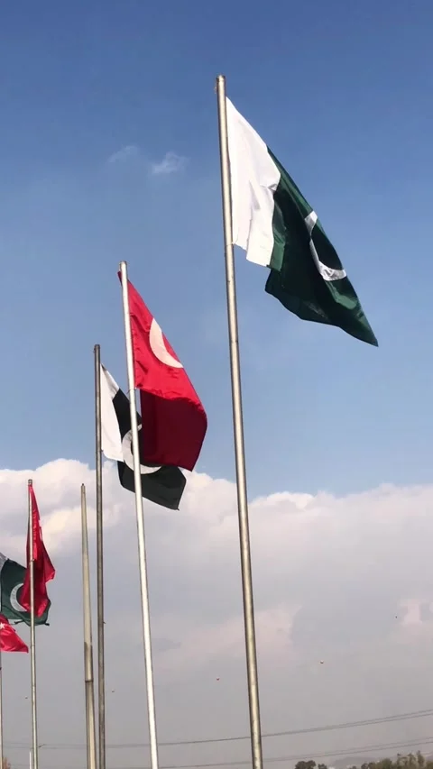 Pakistan and Turkey two flags on flagpoles and blue cloudy sky, waving colorful  動画素材 344650264