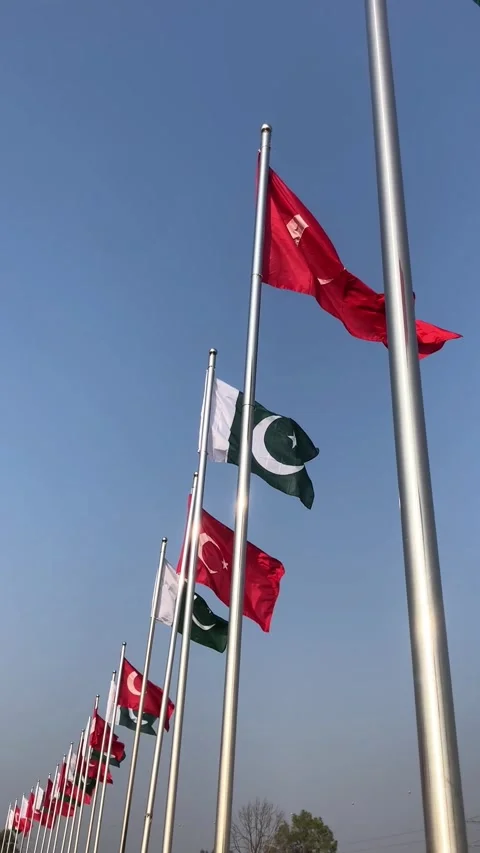 Pakistan and Turkey two flags on flagpoles and blue cloudy sky, waving colorful  스톡 동영상 344654972