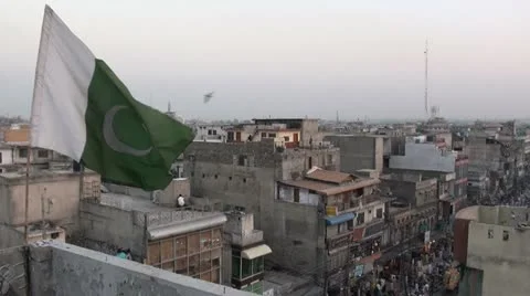 Pakistan flag at Rawalpindi skyline, city, urban Stock Footage