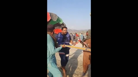Pakistan: Parachute failure leads to splash at Khanpur Dam, Pakistan Video stock 280413099