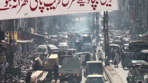 Pakistan traffic jam busy road bazaar banner language Islamabad Stock Footage