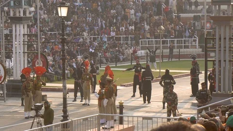 Pakistani and Indian Border Security Guards in Uniforms Kicking at Wagah Border Stock Footage 129346984