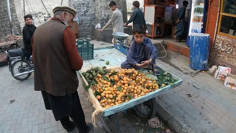 Pakistani boy is selling fruit Stock Footage 113615614