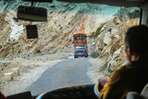 Pakistani decorated truck on mountain road in the Karakoram highway, Pakistan. Stock Photos