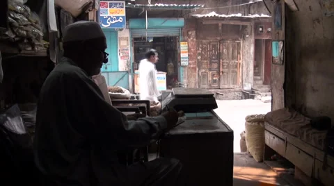 Pakistani man checks balance sheets and counts money Stock Footage 4883902