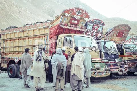 Pakistani men and their beautiful decorated trucks. Stock Photos
