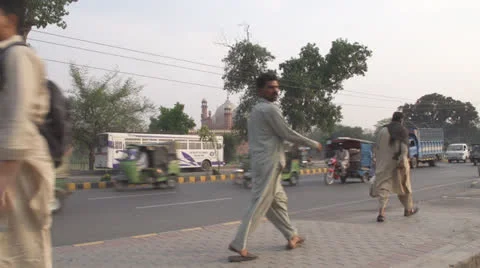 Pakistani Men Walking in front of a Mosque Stock Footage 24805325