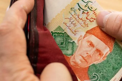 Pakistani Rupees Taking Out of a Wallet. close up Stock Photos