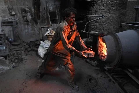 Pakistani workers at an iron die-casting factory in Karachi, Pakistan - 10 Sep 2 Stock Photos