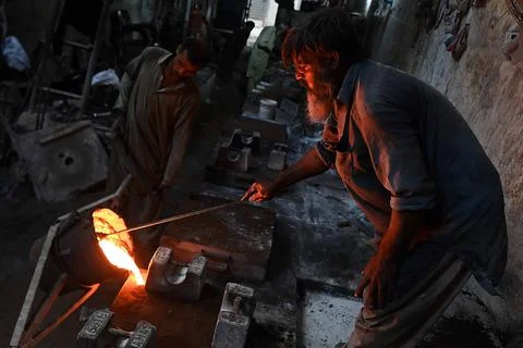 Pakistani workers at an iron die-casting factory in Karachi, Pakistan - 10 Sep 2 Stock Photos
