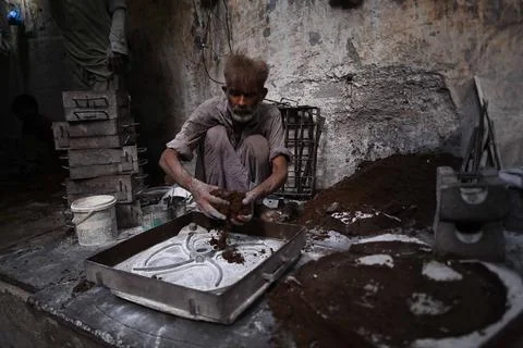 Pakistani workers at an iron die-casting factory in Karachi, Pakistan - 10 Sep 2 Stock Photos