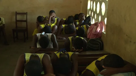 PAKRO STUDENTS PRAY IN A CLASSROOM Stock Footage 58930787