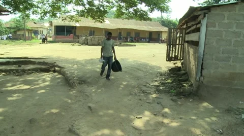 PAKRO YOUN MAN WALKS DOWN PATH CARRYING EMPTY WATER BIN Stock Footage 58930514