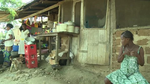 PAKRO YOUNG MAN EXITS HOUSE WITH WATER CONTAINER Stock Footage 58930461