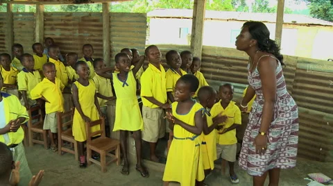 PAKRO: YOUNG STUDENTS AND TEACHER SING IN CLASSROOM Stock Footage 58107429