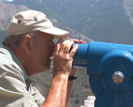 PAL: Man looking through telescope Stock Footage 590520