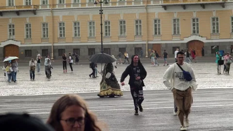 Palace Square during the rain, people without umbrellas run for cover Stock Footage 289564439