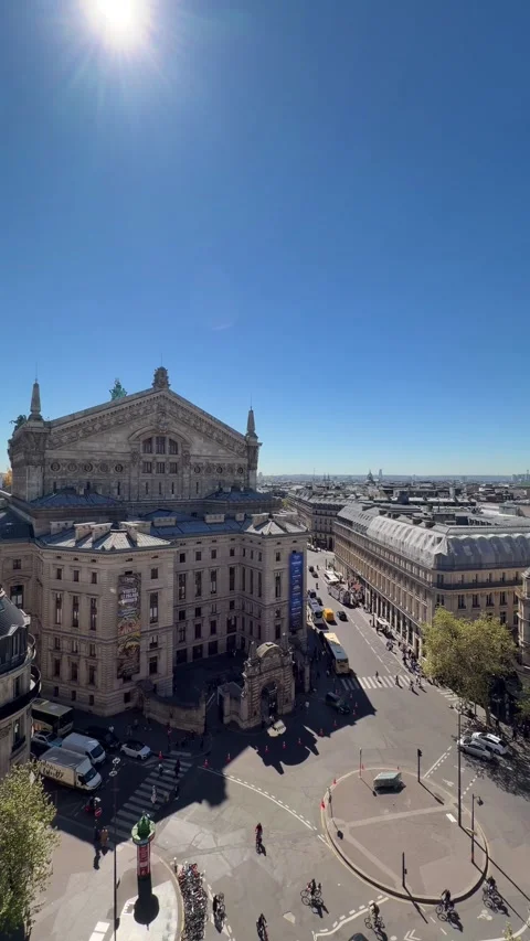 Palais Garnier opera house and city traffic on Boulevard Haussmann in Paris Stock Footage 337783092