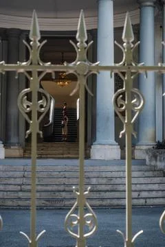 Palatial Hallway Seen through Decorative Iron Fencing 스톡 사진
