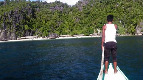 Palawan Philippines - June 24, 2016:  A man maneuvering a boat Stock Footage 287797159