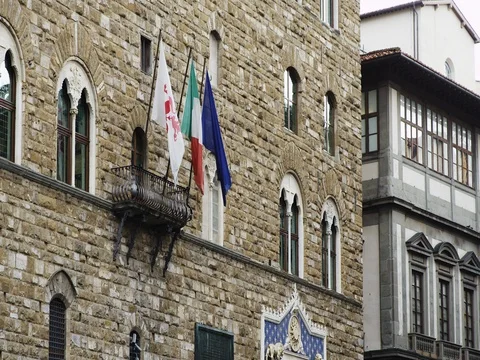 The Palazzo Vecchio Museum and Tower. The flags of Italy and Florence and the EU Stock Footage 75440159