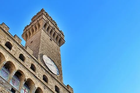 Palazzo Vecchio's clock tower soars against Florence's blue sky Stock Photos