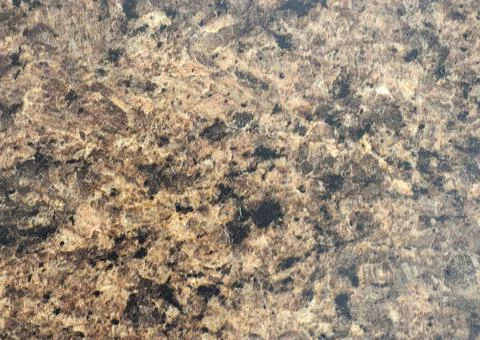 Pale brown marble with a scattering of small black inclusions, a close-up of Stock Photos