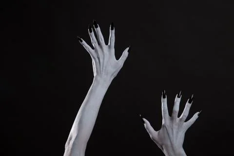 Pale ghost or witch hands with sharp black nails Stock Photos